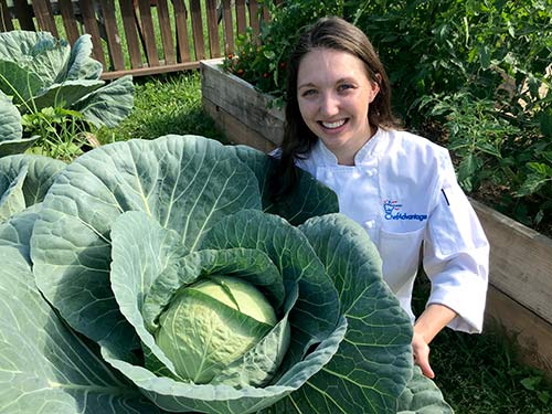 Chef Kristina with Veggies in our Garden