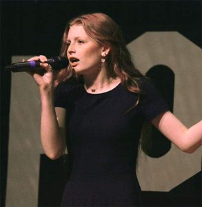 Female student singing with microphone